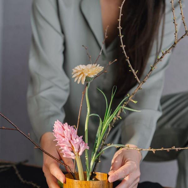 Woman meditating peacefully in a cozy room setting.
